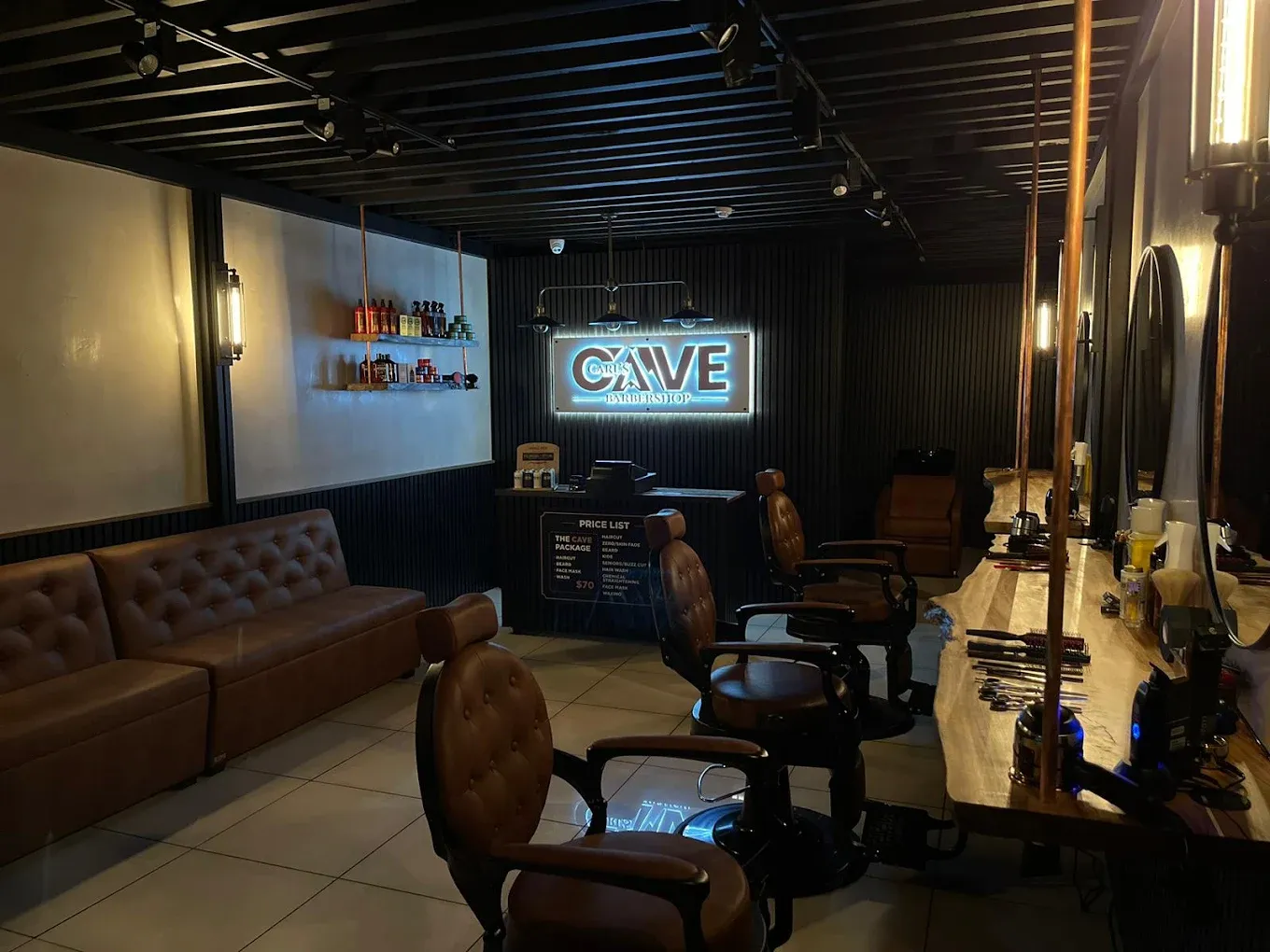 Inside Carl's Cave Barbershop — leather chairs and warm lighting